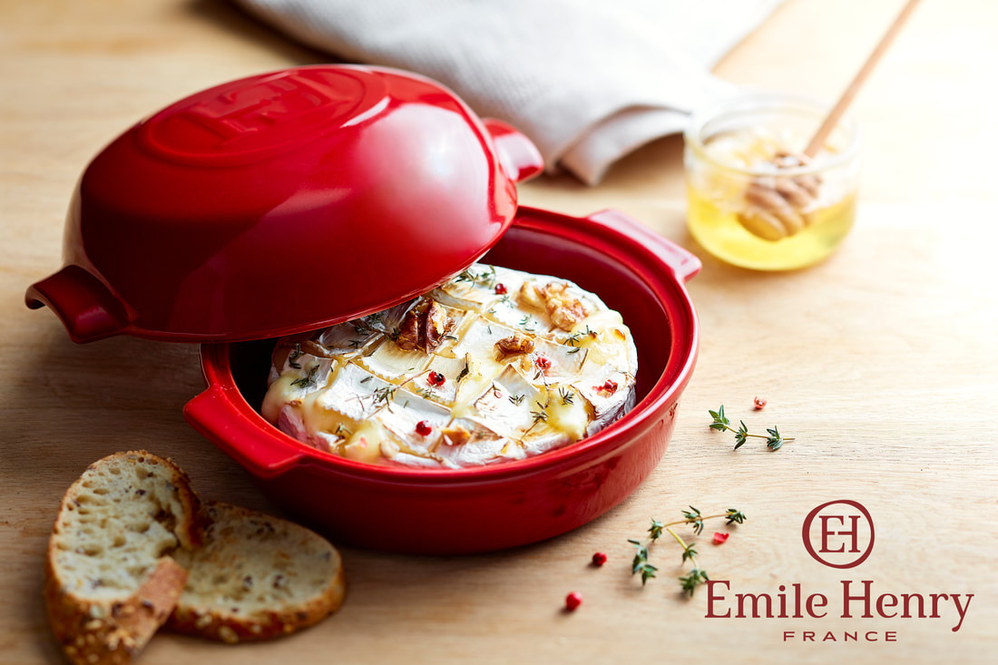 Emile Henry cheese baker with brie and honey in a bowl. 