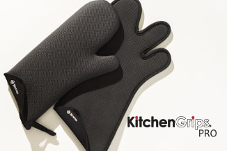Kitchen Grip mitt, handle cover and pot grabbers with potatoes in a roasting pan. 